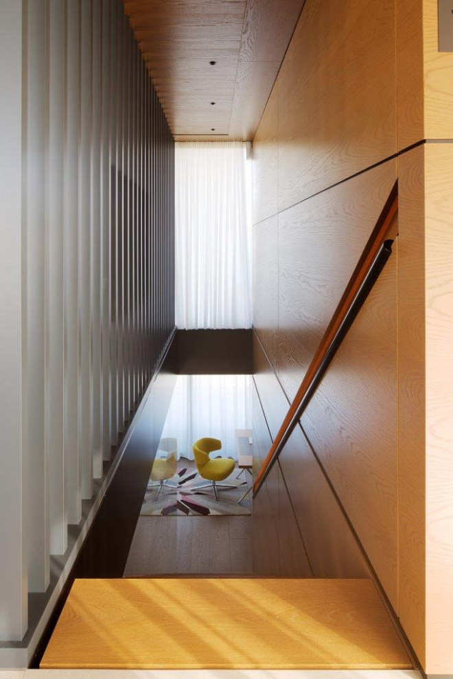 Ejemplo de escalera recta actual extra grande con escalones de madera pintada, contrahuellas de madera pintada, barandilla de metal y panelado