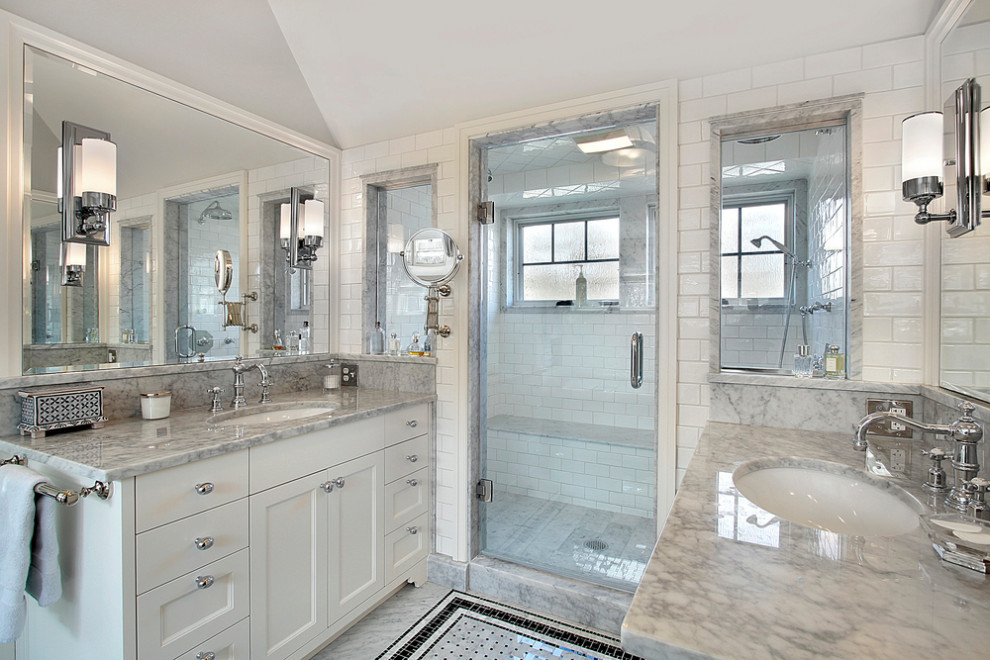 Design ideas for a large contemporary master bathroom in New York with a corner tub, ceramic tile, granite benchtops, flat-panel cabinets, white cabinets, gray tile, white benchtops, a double vanity, a built-in vanity, white walls, an undermount sink, white floor, a hinged shower door, a shower seat and vaulted.
