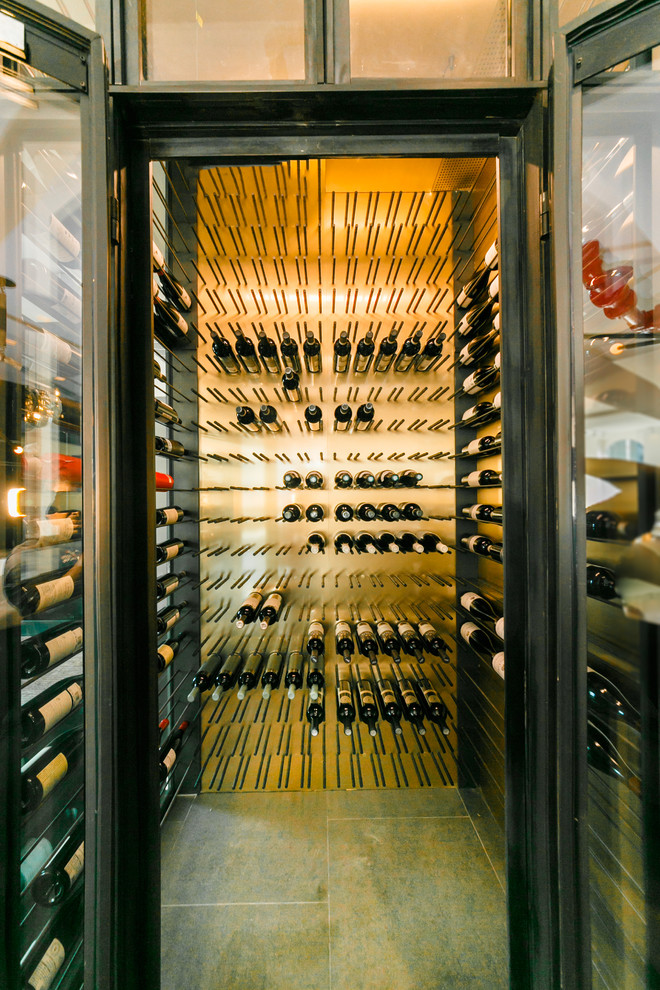Design ideas for a mid-sized modern wine cellar in New York with slate floors and display racks.