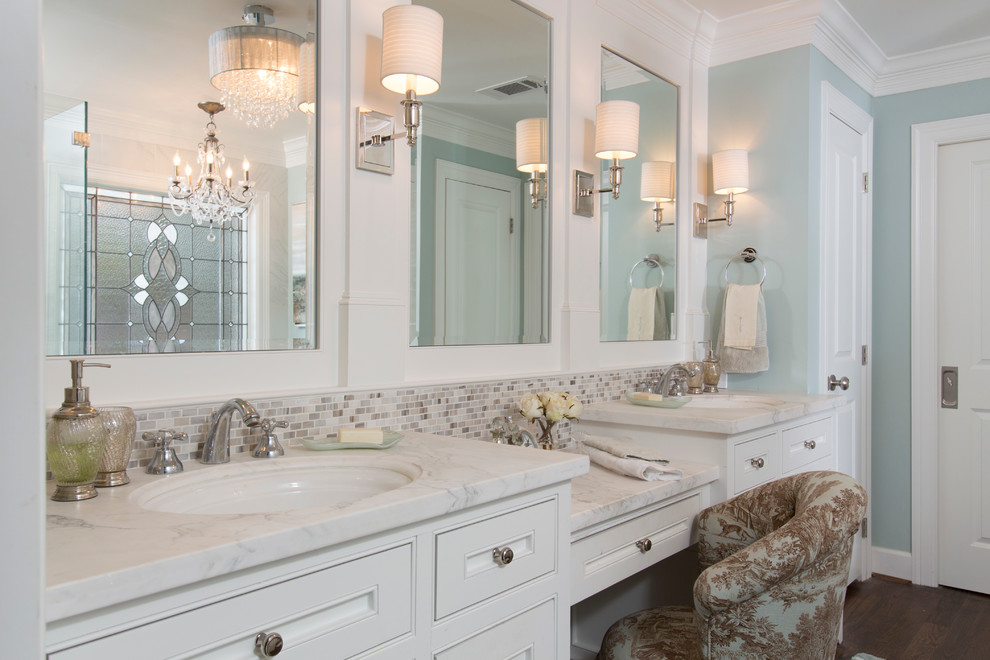 Inspiration for an expansive traditional master bathroom in Houston with an undermount sink, white cabinets, mosaic tile, blue walls, dark hardwood floors, beige tile, gray tile, marble benchtops, brown floor, white benchtops, recessed-panel cabinets, a claw-foot tub, a double vanity and a built-in vanity.