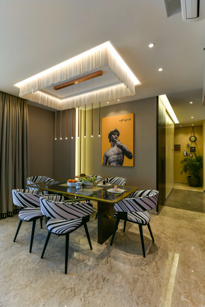 Photo of a large contemporary dining room in Mumbai with grey walls and grey floor.
