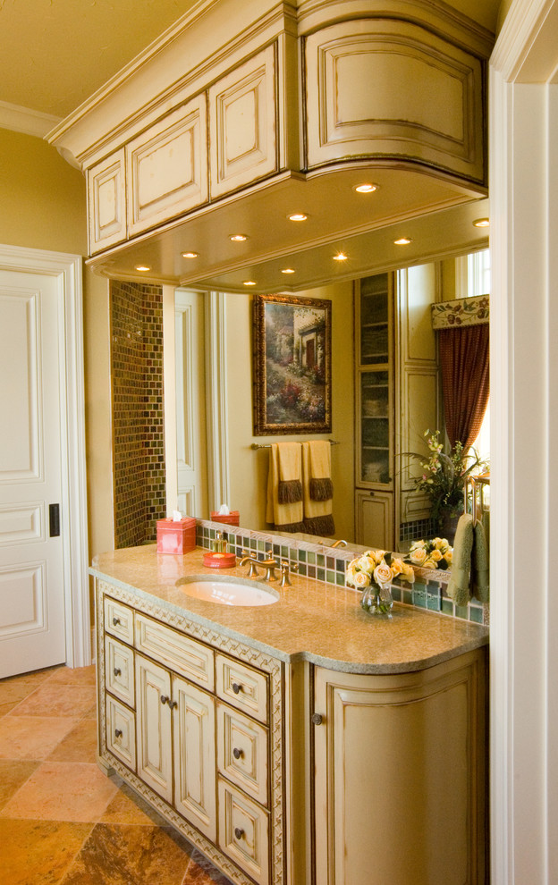 Inspiration for a mid-sized traditional bathroom in Charlotte with raised-panel cabinets.