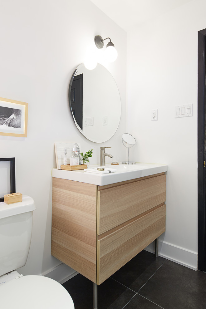 Photo of a scandinavian bathroom in Montreal with a console sink, flat-panel cabinets, light wood cabinets and white walls.