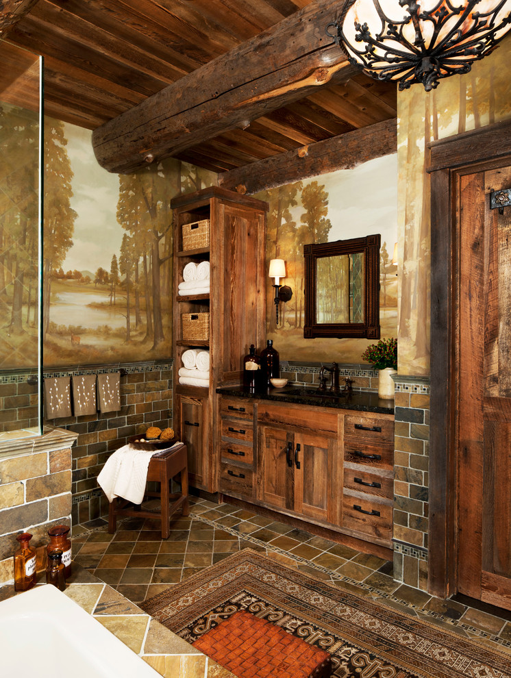 Photo of a mid-sized country master bathroom in Detroit with an undermount tub, a corner shower, medium wood cabinets, brown tile, shaker cabinets, multi-coloured walls, ceramic floors and solid surface benchtops.