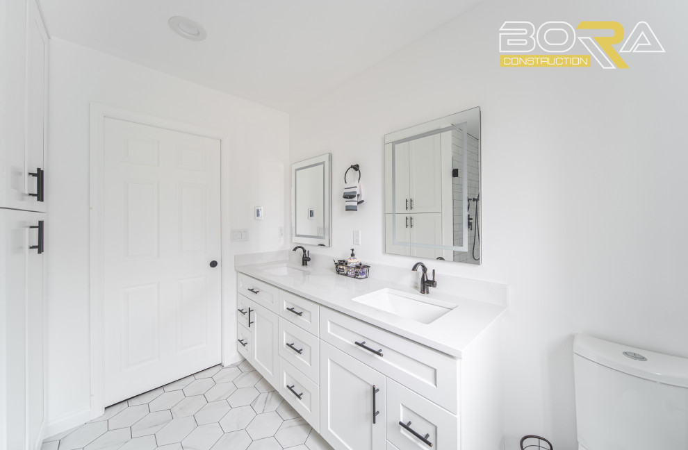 Idéer för ett mellanstort klassiskt vit en-suite badrum, med skåp i shakerstil, vita skåp, en dusch i en alkov, en toalettstol med separat cisternkåpa, vit kakel, keramikplattor, vita väggar, cementgolv, ett undermonterad handfat, bänkskiva i kvarts, vitt golv och dusch med gångjärnsdörr