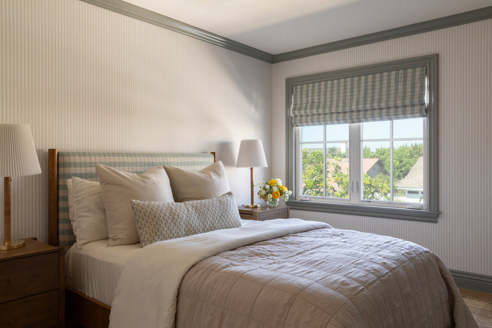 Bedroom - coastal medium tone wood floor, brown floor and wallpaper bedroom idea in Orange County with beige walls