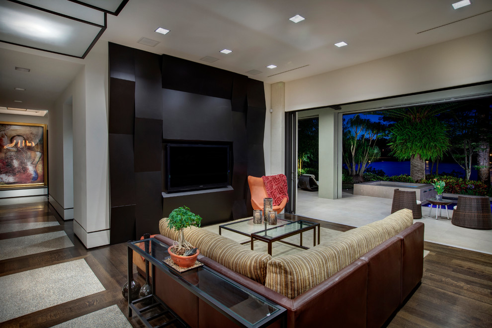 Contemporary formal open concept living room in Orlando with dark hardwood floors, no fireplace and a built-in media wall.