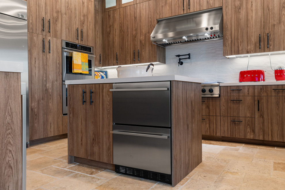 Mountain style l-shaped slate floor and beige floor enclosed kitchen photo with a single-bowl sink, flat-panel cabinets, medium tone wood cabinets, quartzite countertops, white backsplash, glass sheet backsplash, stainless steel appliances, a peninsula and white countertops