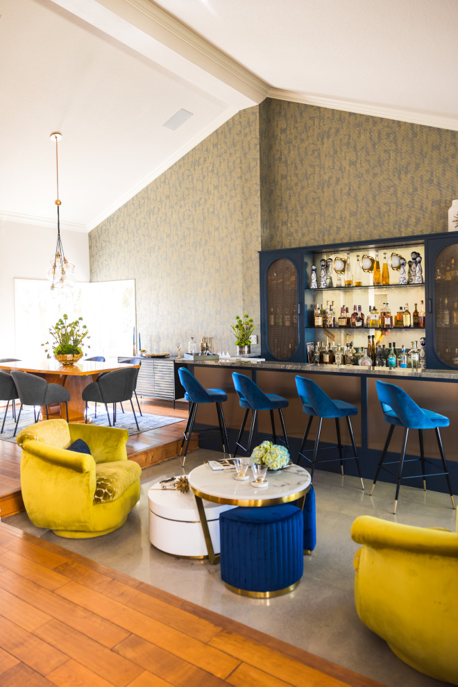Design ideas for a mid-sized midcentury home bar in Orange County with no sink, shaker cabinets, blue cabinets, quartzite benchtops, multi-coloured splashback, mirror splashback, concrete floors, grey floor and multi-coloured benchtop.