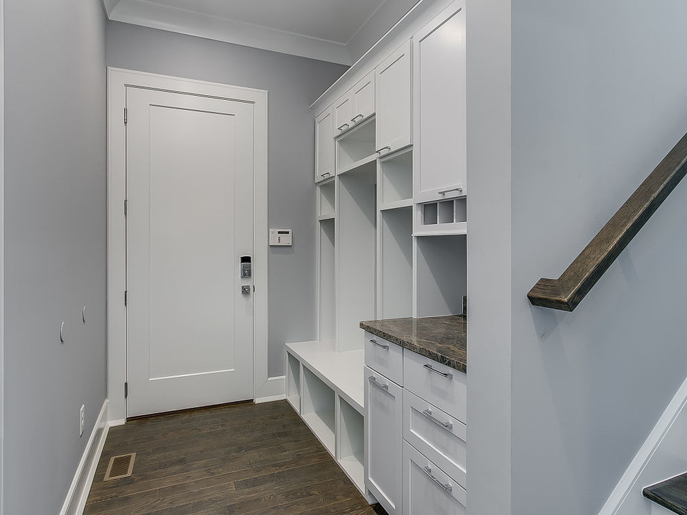 Inspiration for a mid-sized transitional dark wood floor and brown floor mudroom remodel with gray walls