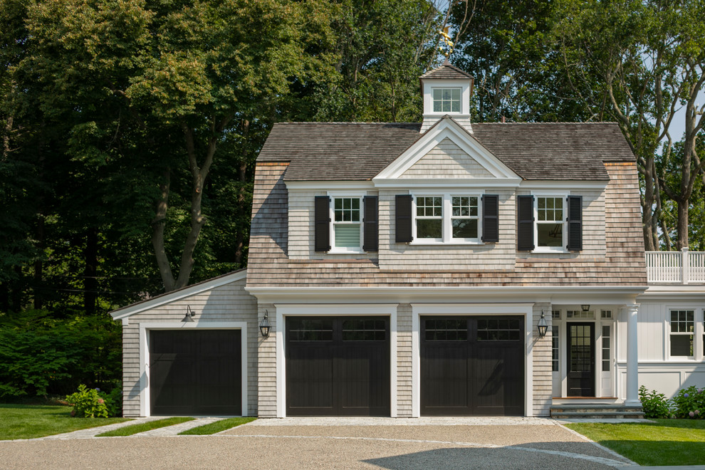Photo of a traditional attached three-car garage in Boston.