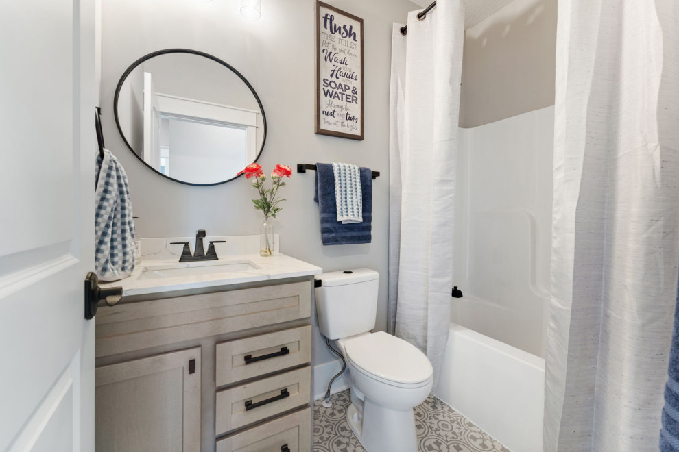 Design ideas for a small transitional kids bathroom in Minneapolis with shaker cabinets, grey cabinets, an alcove tub, a shower/bathtub combo, a two-piece toilet, grey walls, ceramic floors, an undermount sink, engineered quartz benchtops, grey floor, a shower curtain, white benchtops, a single vanity and a built-in vanity.