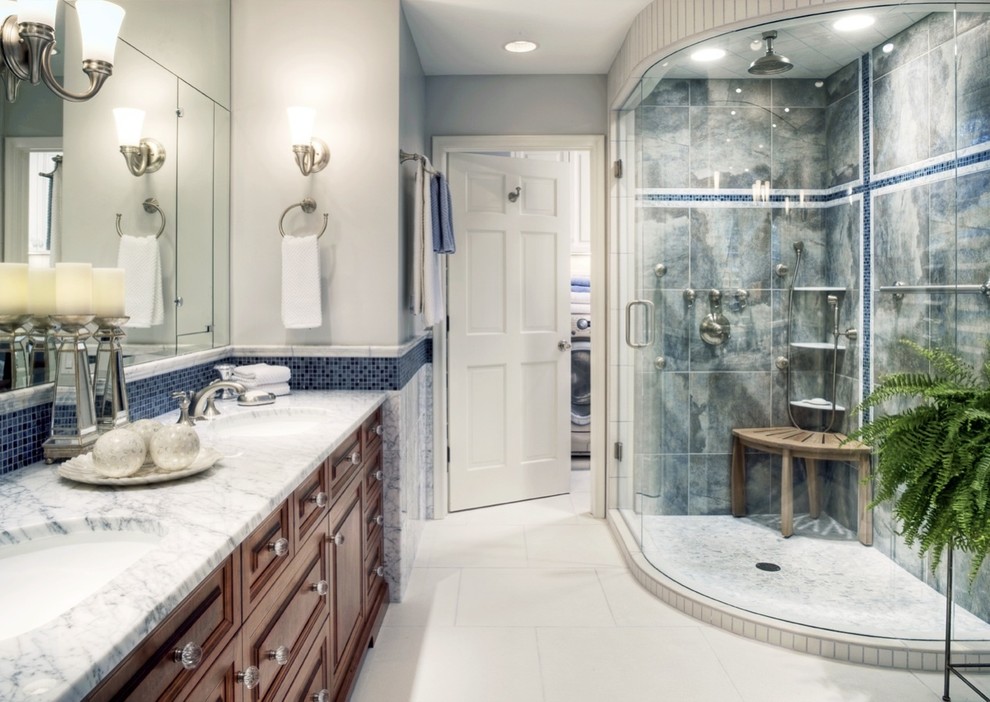 This is an example of a mid-sized transitional 3/4 bathroom in Omaha with raised-panel cabinets, dark wood cabinets, a corner shower, blue tile, porcelain tile, grey walls, porcelain floors, an undermount sink, granite benchtops, white floor and a hinged shower door.