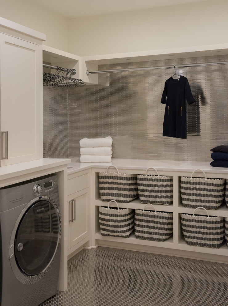 Photo of a large beach style l-shaped dedicated laundry room in New York with open cabinets, white cabinets, solid surface benchtops, white walls, porcelain floors, a side-by-side washer and dryer and an undermount sink.