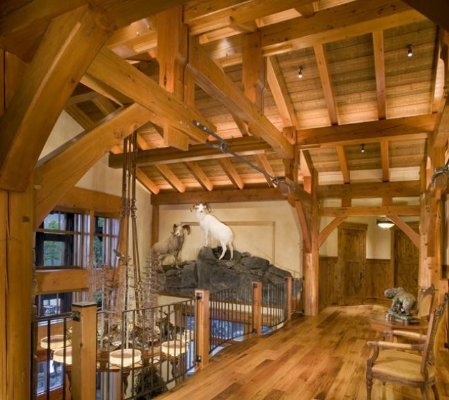 Inspiration for a large rustic medium tone wood floor and brown floor hallway remodel with beige walls
