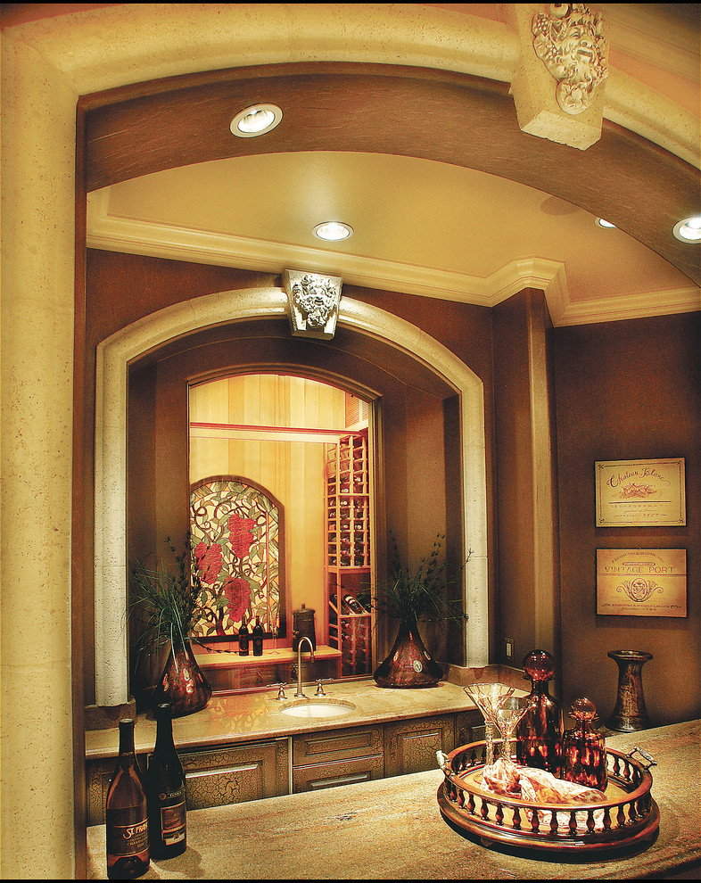 Photo of a mid-sized mediterranean wine cellar in Miami with travertine floors and display racks.