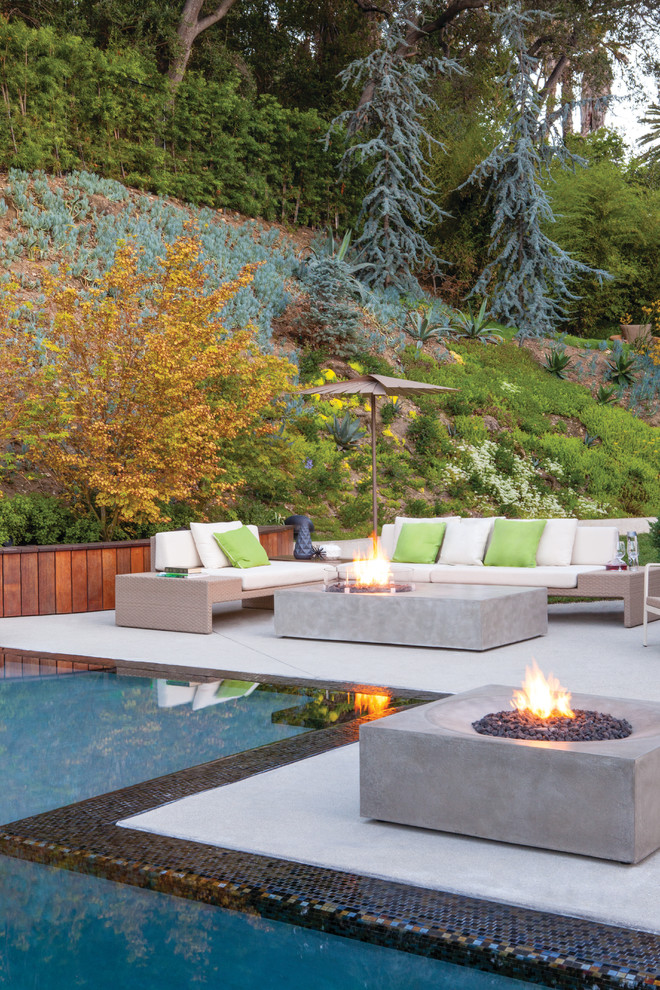 Inspiration for a contemporary backyard patio in New York with a fire feature, concrete slab and no cover.