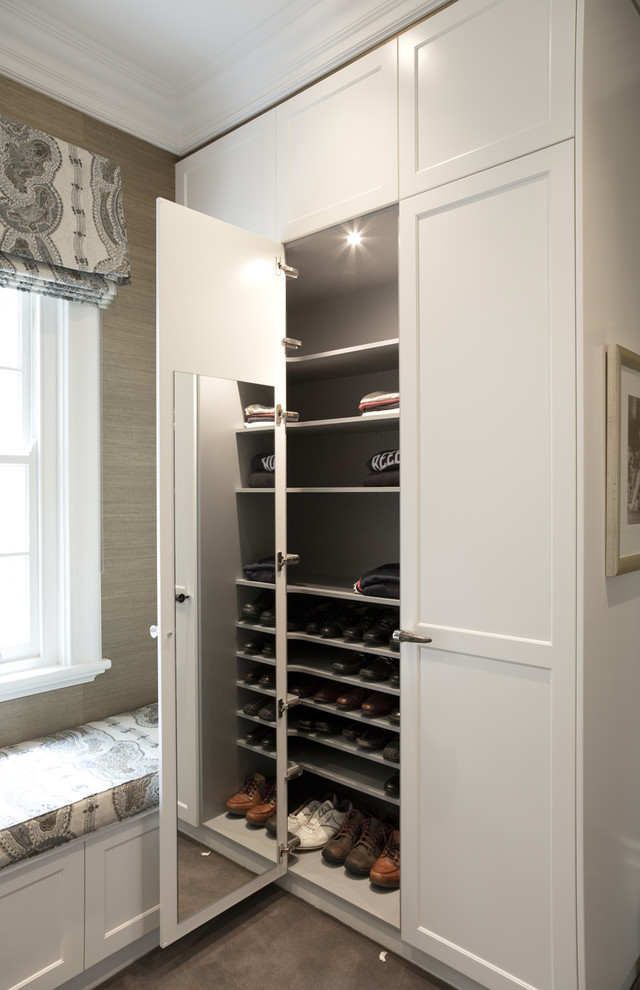 This is an example of a mid-sized traditional men's walk-in wardrobe in Sydney with shaker cabinets, white cabinets and carpet.