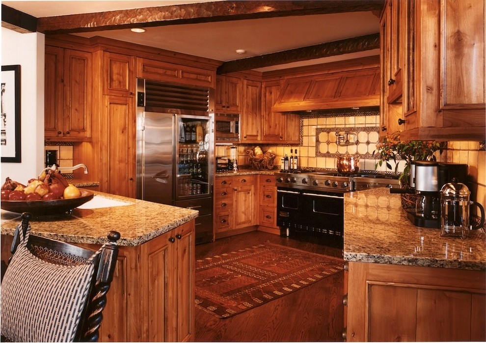 Inspiration for a large rustic medium tone wood floor kitchen remodel in Denver with recessed-panel cabinets, medium tone wood cabinets, granite countertops, beige backsplash, porcelain backsplash and stainless steel appliances
