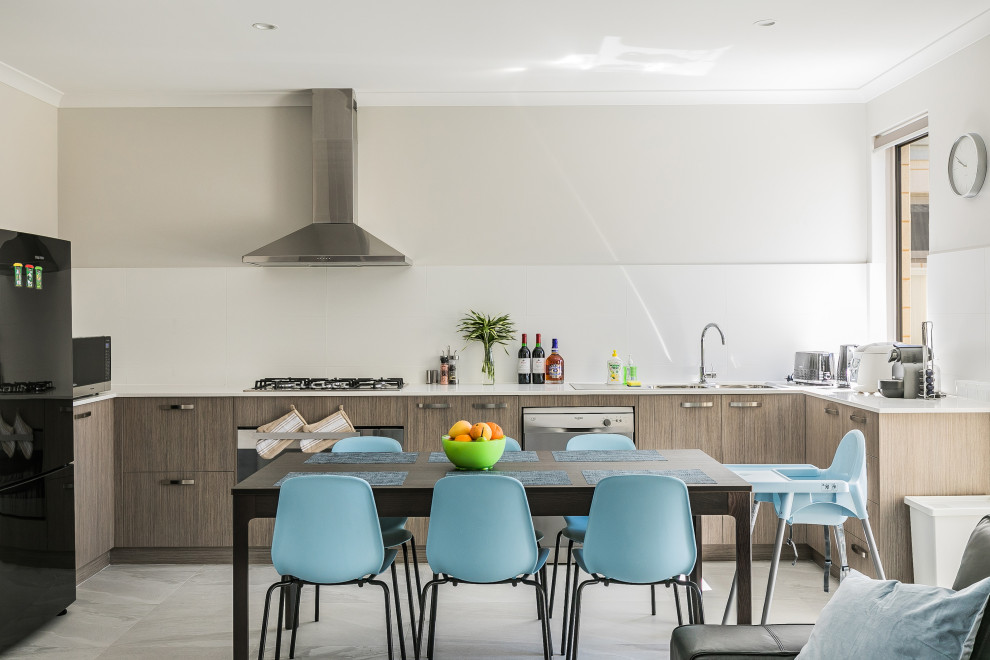 Contemporary open plan kitchen in Perth with a double-bowl sink, flat-panel cabinets, grey floor and white benchtop.