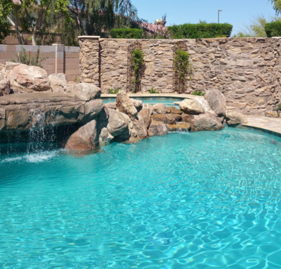 Hot tub - large rustic backyard custom-shaped hot tub idea in Phoenix