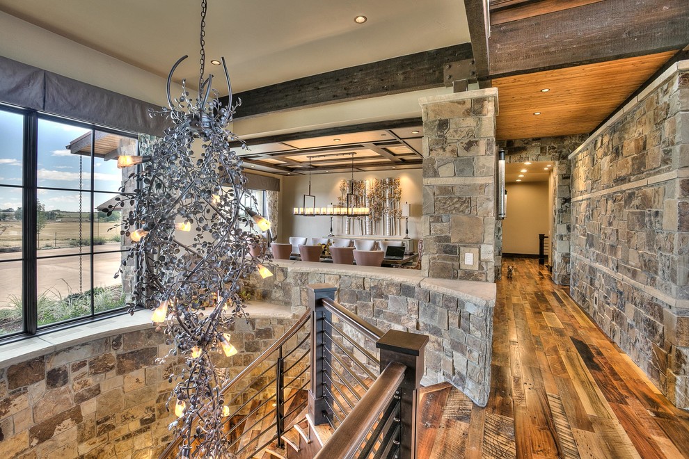 Huge mountain style medium tone wood floor hallway photo in Denver with beige walls