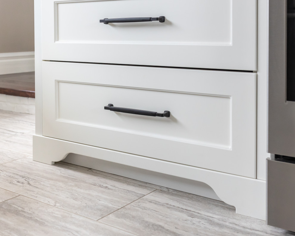 Inspiration for a mid-sized u-shaped vinyl floor and gray floor enclosed kitchen remodel in Toronto with an undermount sink, recessed-panel cabinets, white cabinets, quartz countertops, white backsplash, brick backsplash, stainless steel appliances, an island and white countertops