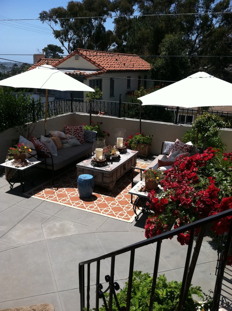 Design ideas for a large mediterranean rooftop and rooftop deck in San Diego with a container garden, an awning and metal railing.
