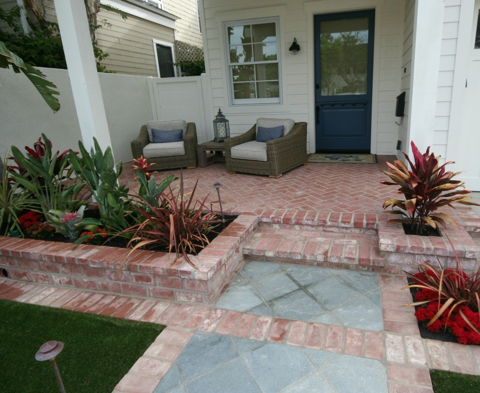 Photo of a mid-sized eclectic front yard garden in San Diego with a garden path and brick pavers.