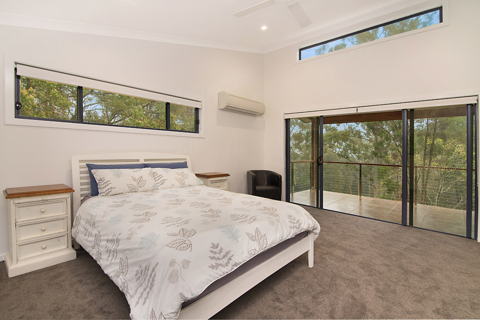 Large transitional master bedroom in Sydney with grey walls, carpet and no fireplace.