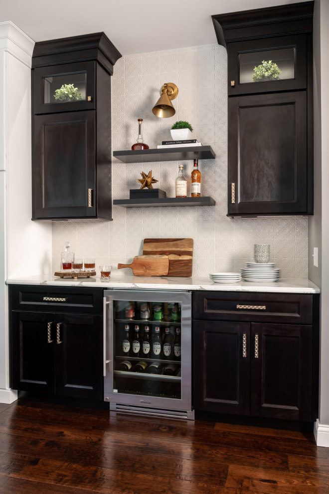 Inspiration for a large transitional l-shaped dark wood floor and brown floor enclosed kitchen remodel in St Louis with a farmhouse sink, shaker cabinets, white cabinets, quartz countertops, white backsplash, subway tile backsplash, stainless steel appliances, an island and white countertops