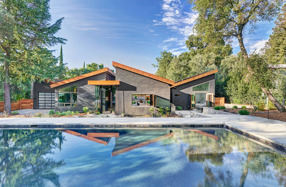 This is an example of an expansive contemporary one-storey black house exterior in Sacramento.