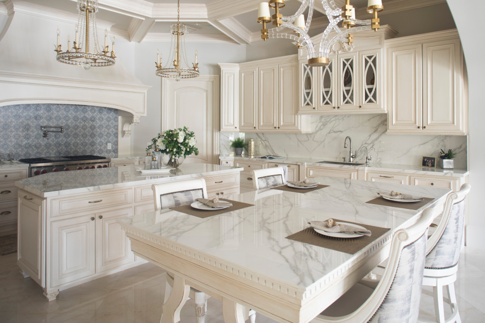 Mediterranean kitchen in Houston with white cabinets, stainless steel appliances, white benchtop and coffered.