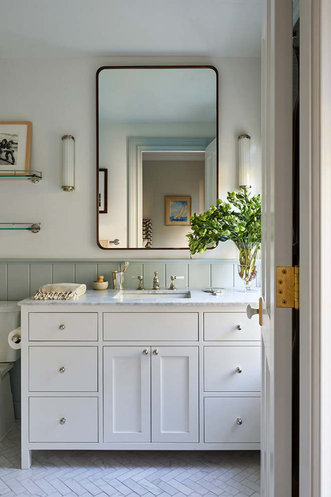 Inspiration for a medium sized classic bathroom in New York with flat-panel cabinets, white cabinets, a two-piece toilet, white walls, marble flooring, a submerged sink, marble worktops, white floors, white worktops, a single sink, a built in vanity unit and tongue and groove walls.