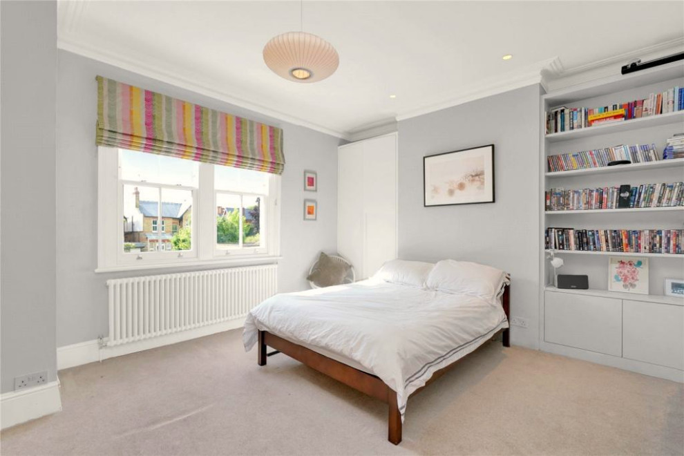 Large trendy guest carpeted and beige floor bedroom photo in London with gray walls