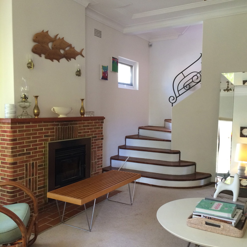 Mid-sized eclectic wood curved staircase in Sydney with painted wood risers and metal railing.