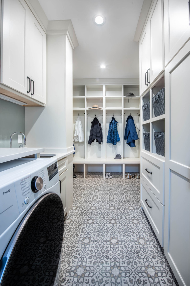 Photo of a small transitional galley utility room in Other with an utility sink, shaker cabinets, white cabinets, quartzite benchtops, vinyl floors, a side-by-side washer and dryer and white benchtop.