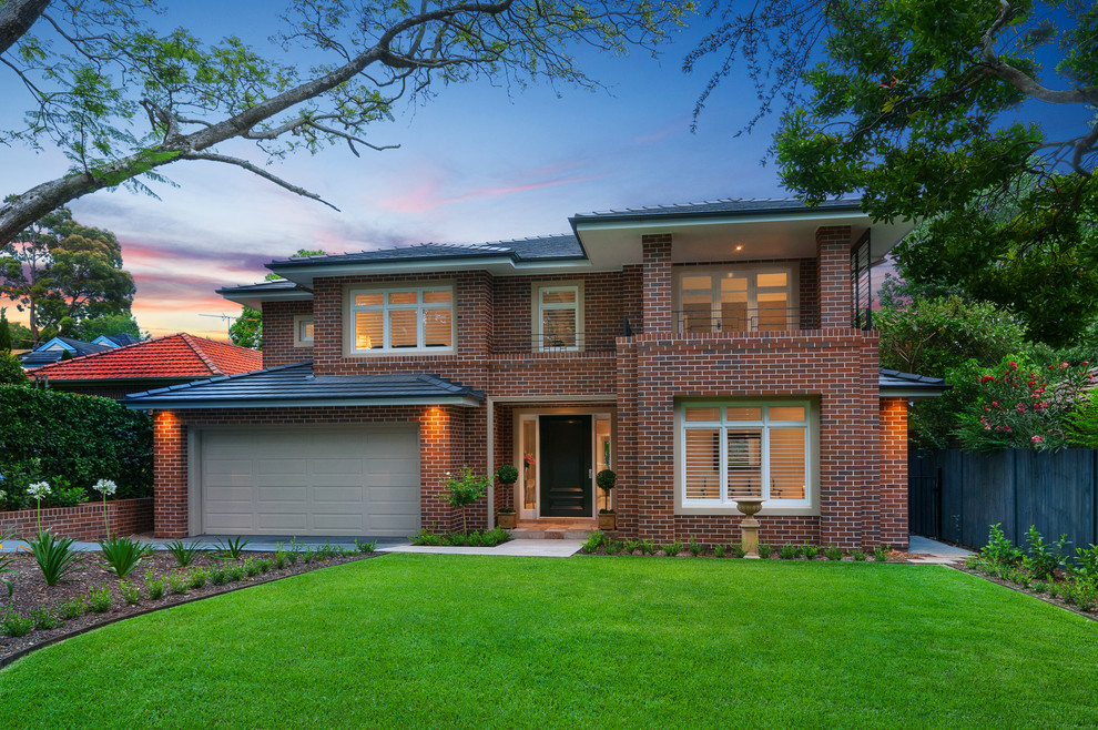 Large contemporary two-storey brick brown exterior in Sydney with a hip roof.