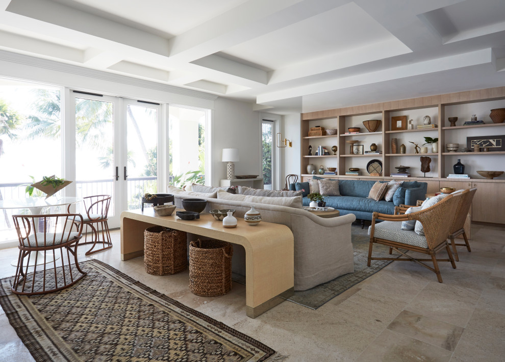 This is an example of a world-inspired games room in Miami with white walls and beige floors.