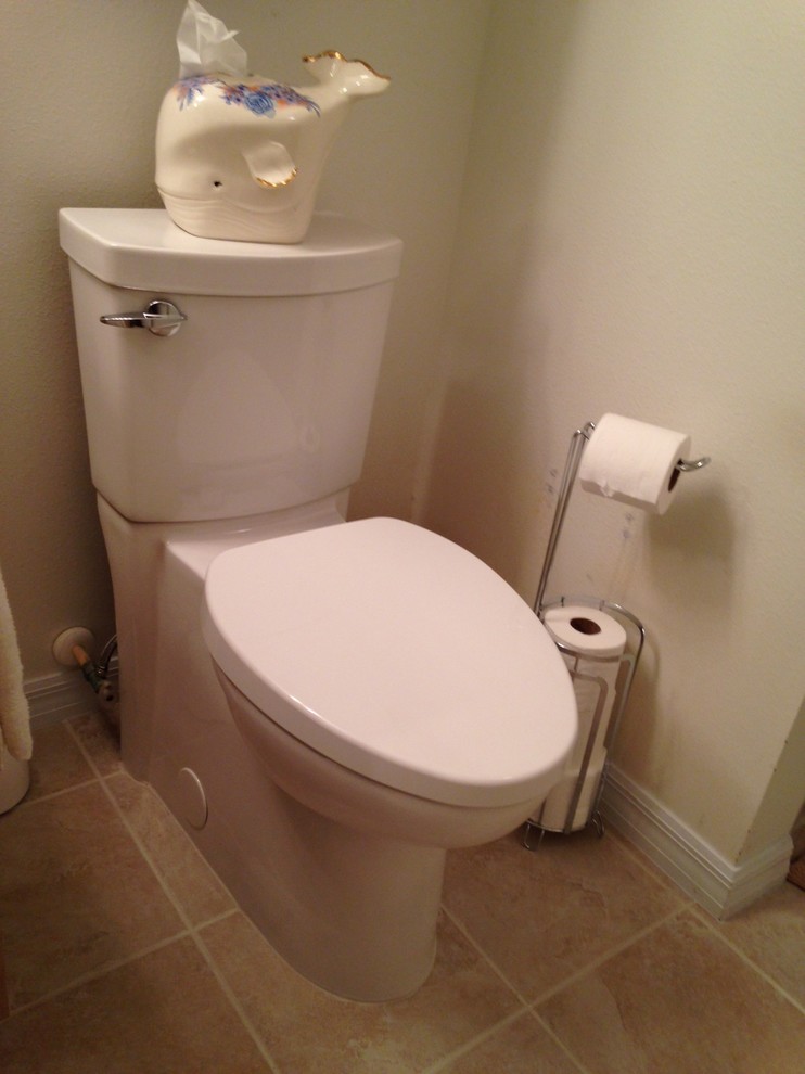 This is an example of a mid-sized traditional 3/4 bathroom in Orlando with a two-piece toilet, beige tile, porcelain tile and porcelain floors.