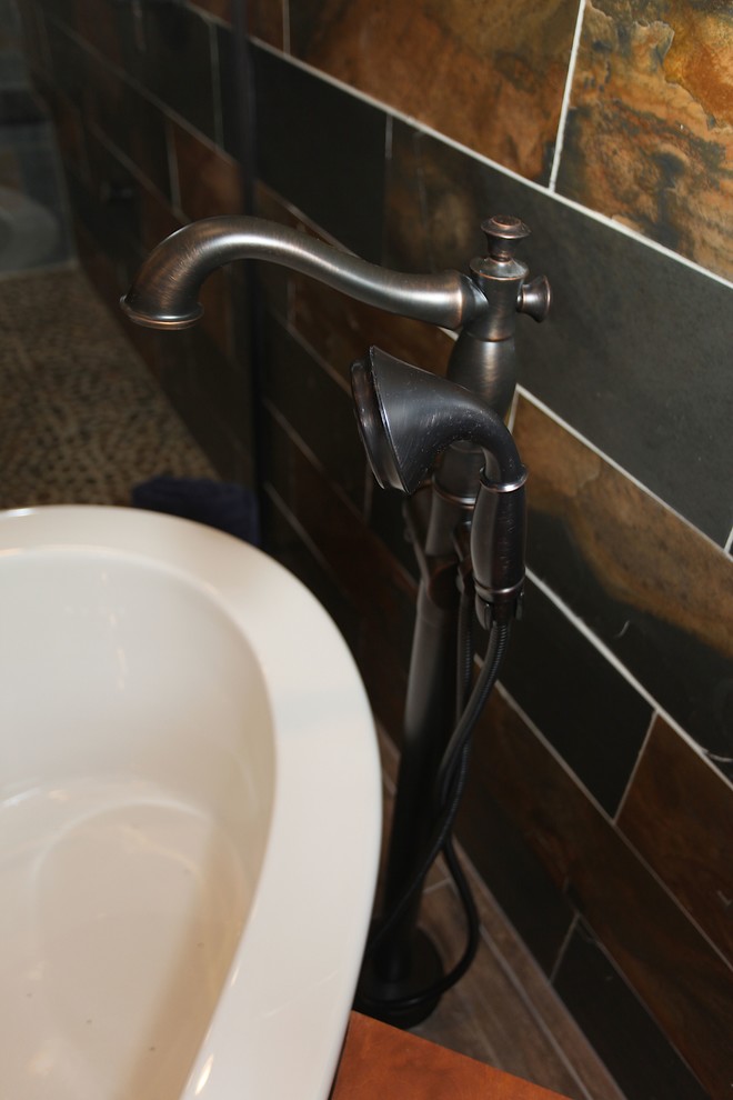 Large mountain style master slate tile brown floor home design photo in Indianapolis with brown cabinets, beige walls and an undermount sink