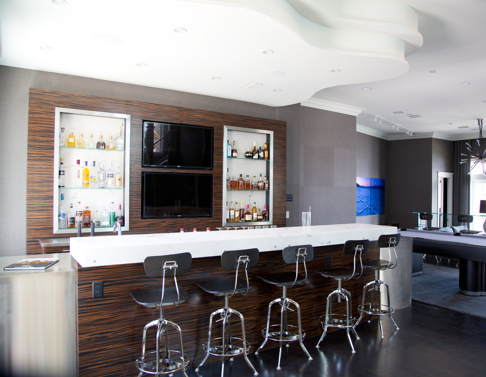Photo of a large contemporary single-wall wet bar in Miami with an undermount sink, stainless steel benchtops and dark hardwood floors.