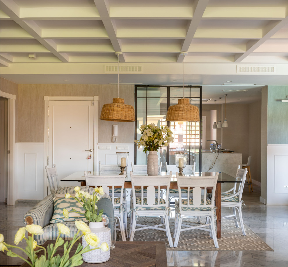 Exemple d'une grande salle à manger ouverte sur le salon chic avec un mur beige, un sol en marbre, une cheminée standard, un sol gris, un plafond à caissons et du papier peint.