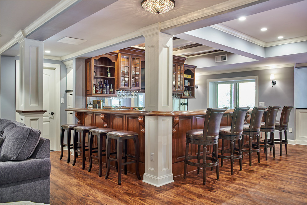 This is an example of a traditional home bar in New York with medium hardwood floors.