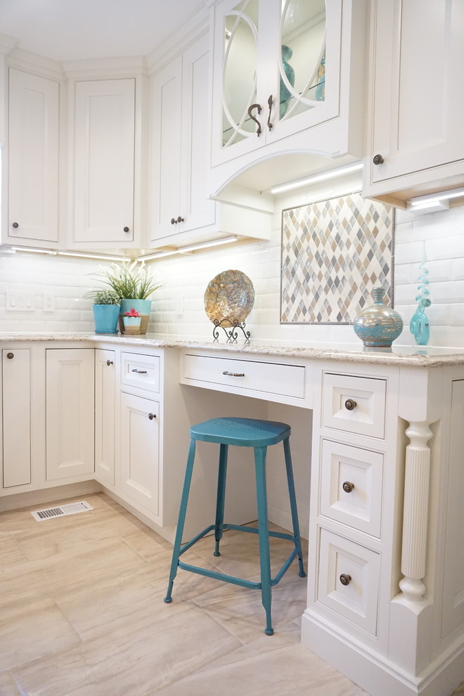 Photo of a mid-sized transitional eat-in kitchen in St Louis with white cabinets, quartz benchtops, white splashback, subway tile splashback and with island.