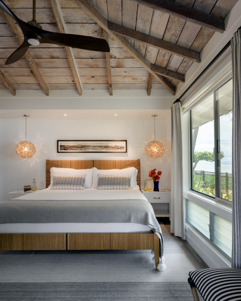 Inspiration for a mid-sized beach style master bedroom in Hawaii with white walls, porcelain floors, grey floor, exposed beam and planked wall panelling.