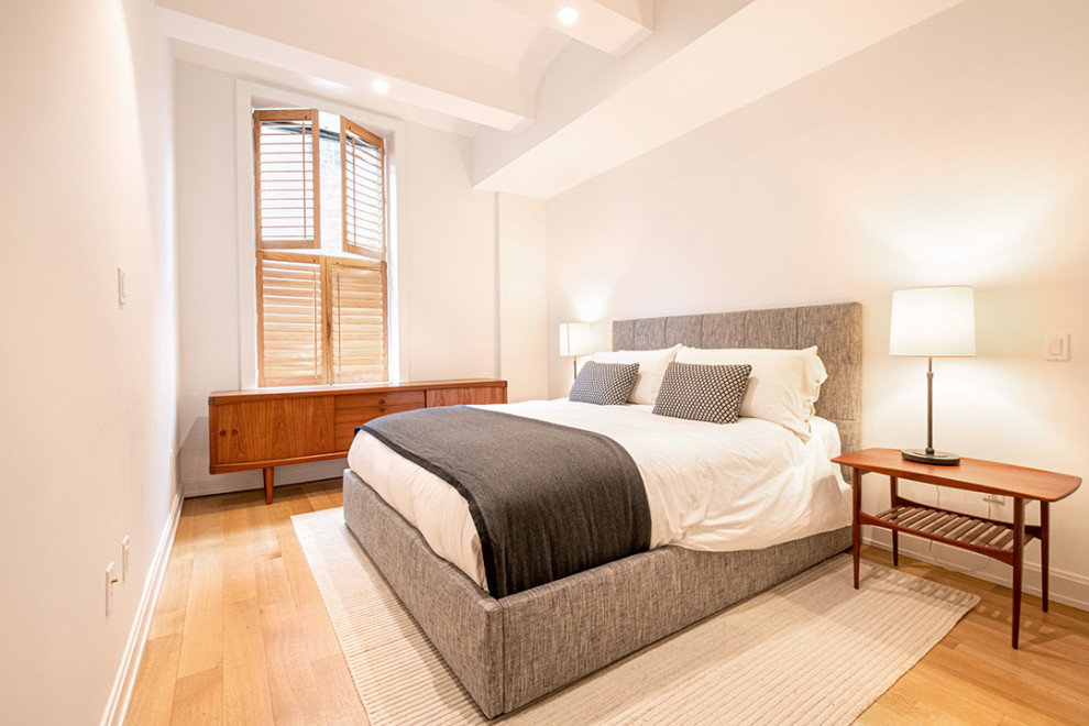 Идея дизайна: гостевая спальня среднего размера, (комната для гостей) в стиле ретро с белыми стенами, паркетным полом среднего тона, коричневым полом и сводчатым потолком