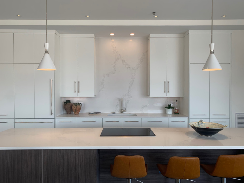 Example of a large trendy galley concrete floor open concept kitchen design in New Orleans with flat-panel cabinets, white cabinets, paneled appliances and an island