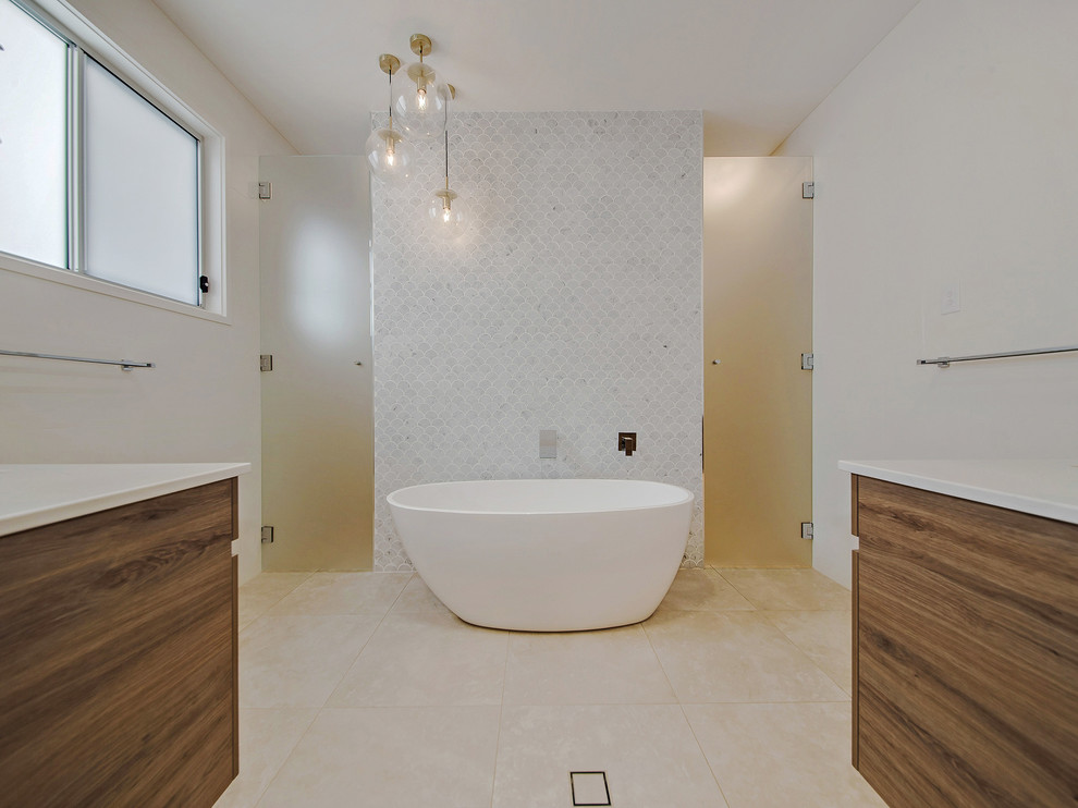 Large contemporary master wet room bathroom in Brisbane with flat-panel cabinets, dark wood cabinets, a freestanding tub, white tile, marble, white walls, an undermount sink, granite benchtops, beige floor and a hinged shower door.