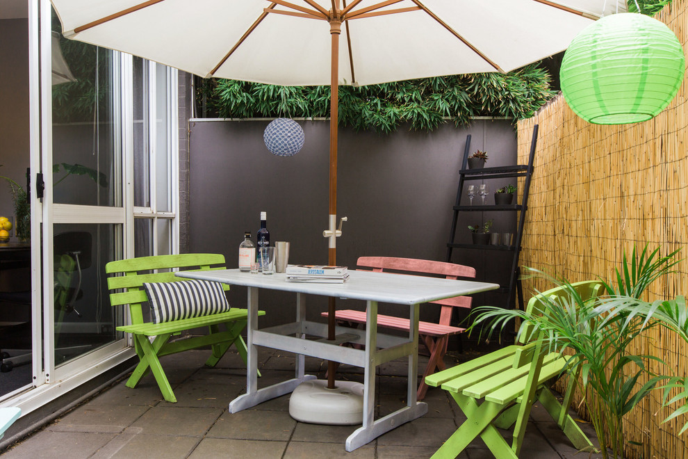 Design ideas for a mid-sized eclectic courtyard patio in Melbourne with a vertical garden and concrete pavers.